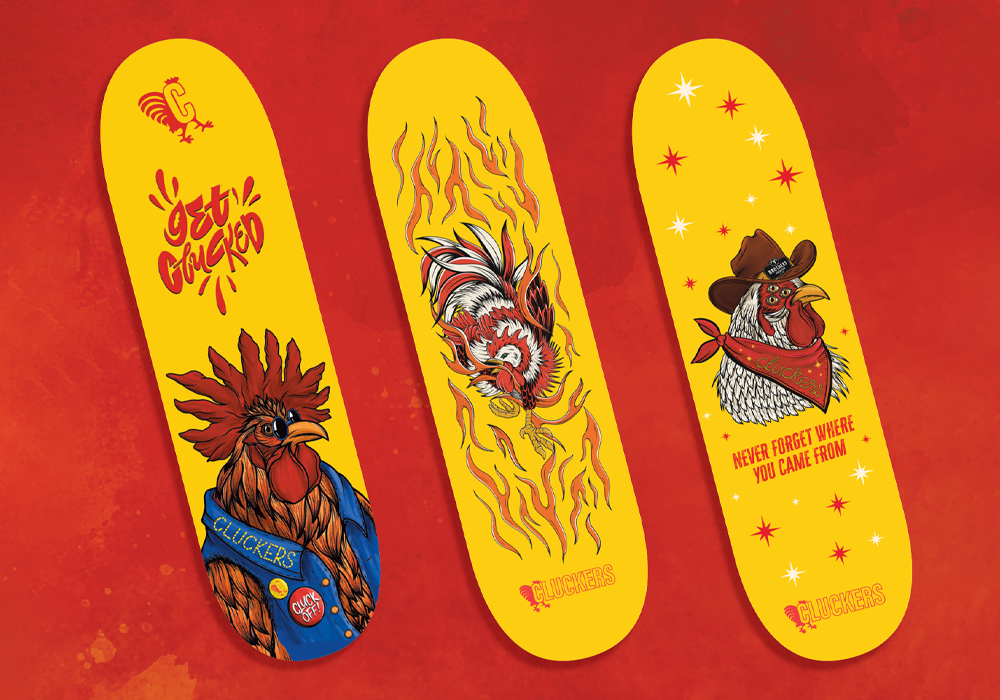 Three yellow skateboards next to one another with three different chicken illustrated in different styles.